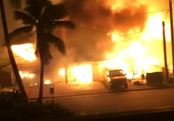 Lahaina fire consuming a building with a van